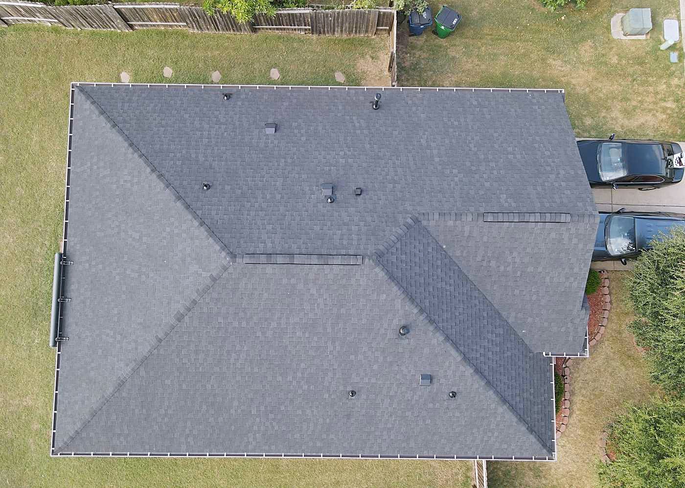 Overhead view of a finished grey shingle roof on a single-story home